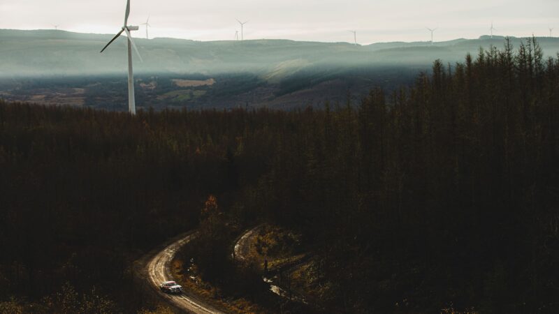 Car on Roger Albert Clark Rally carves past wind turbines
