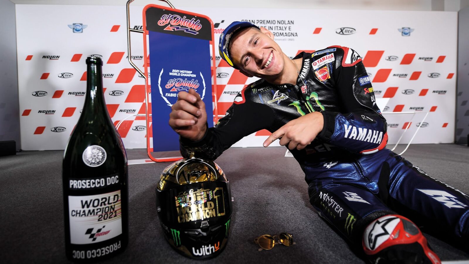 Fabio Quartararo poses with 2021 MotoGP champion helmet