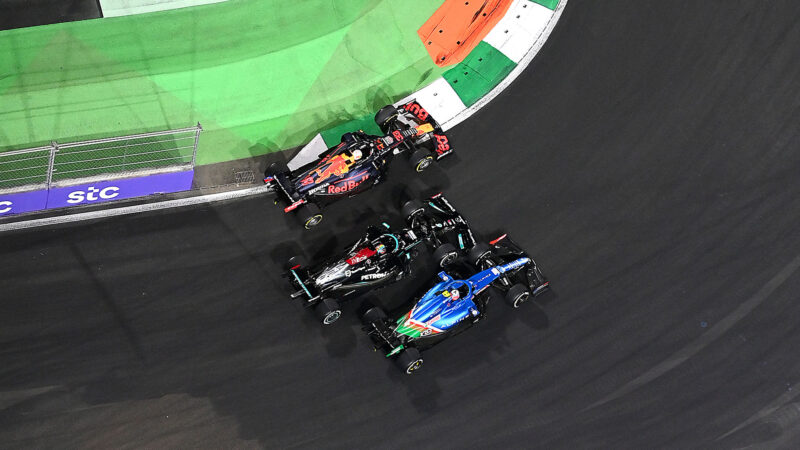 JEDDAH, SAUDI ARABIA - DECEMBER 05: Esteban Ocon of France driving the (31) Alpine A521 Renault, Lewis Hamilton of Great Britain driving the (44) Mercedes AMG Petronas F1 Team Mercedes W12 and Max Verstappen of the Netherlands driving the (33) Red Bull Racing RB16B Honda battle for track position at the second restart during the F1 Grand Prix of Saudi Arabia at Jeddah Corniche Circuit on December 05, 2021 in Jeddah, Saudi Arabia. (Photo by Dan Mullan/Getty Images)