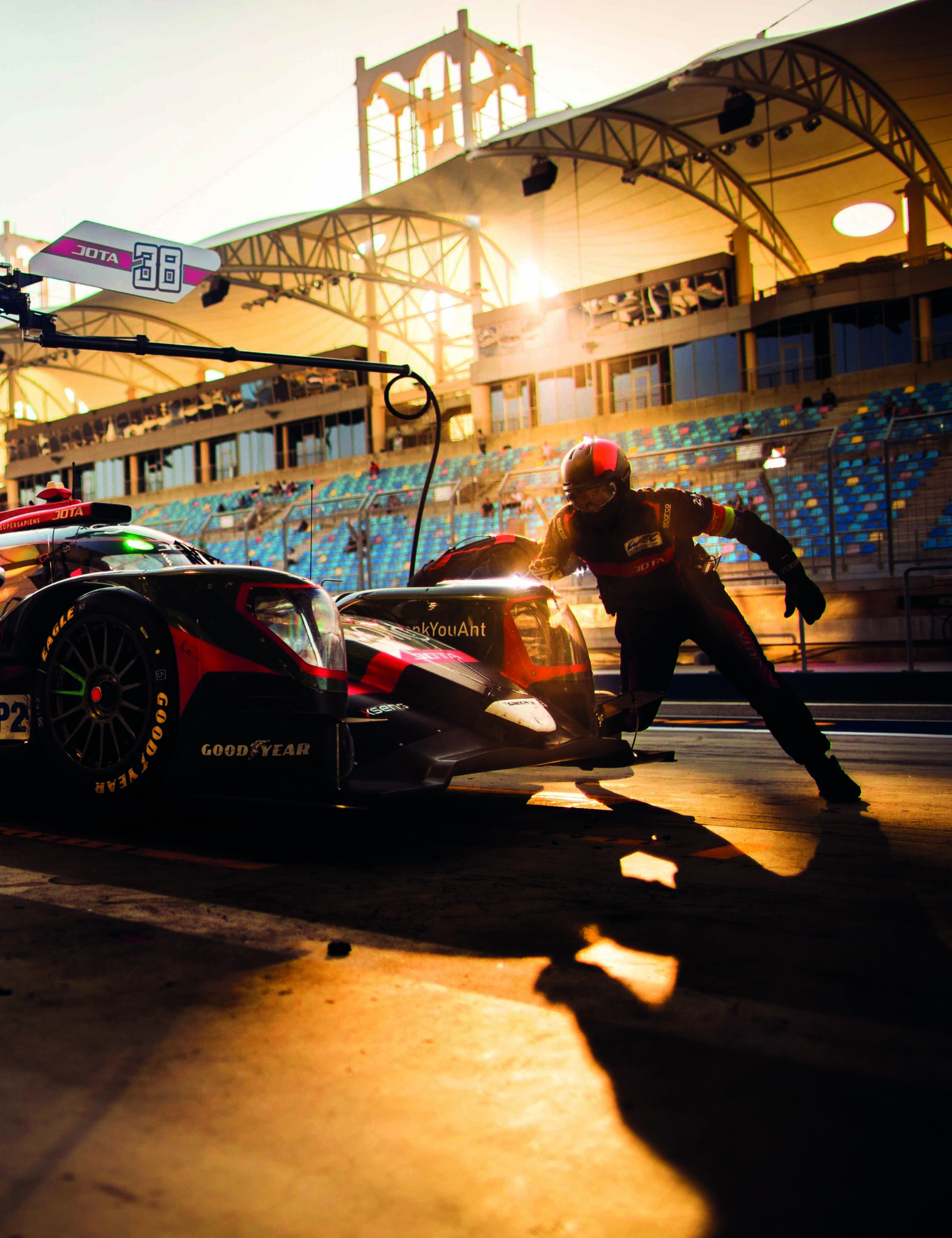 Mechanic runs round car at Le Mans pitstop