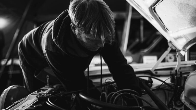 Mechanic works on Hillman Avenger during 2021 Roger Albert Clark Rally