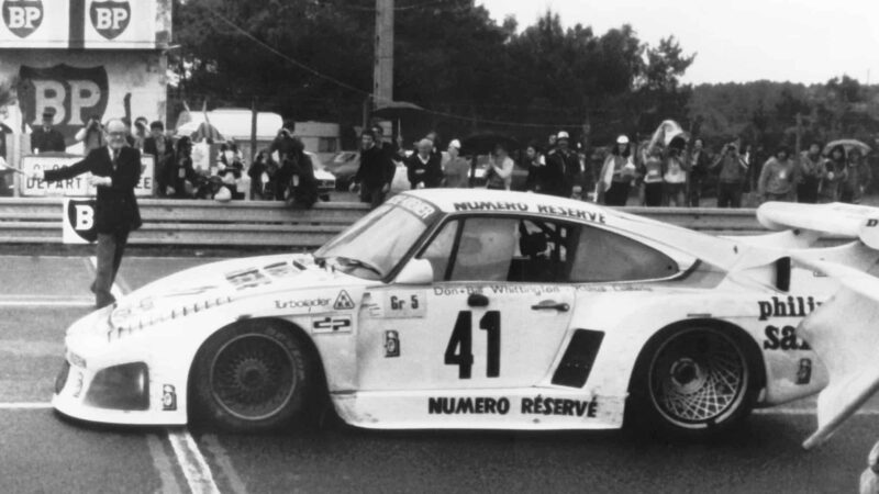 LE MANS, FRANCE - JUNE 10, 1979: Don Whittington takes the checkered flag to win the running of the 24 Hours of Le Mans. Whittington co-drove his Porsche 935 K3 to the victory with his brother Don Whittington and Klaus Ludwig. (Photo by ISC Images and Archives via Getty Images)