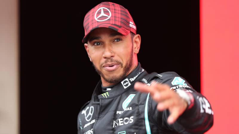 Lewis Hamilton holds arm out
