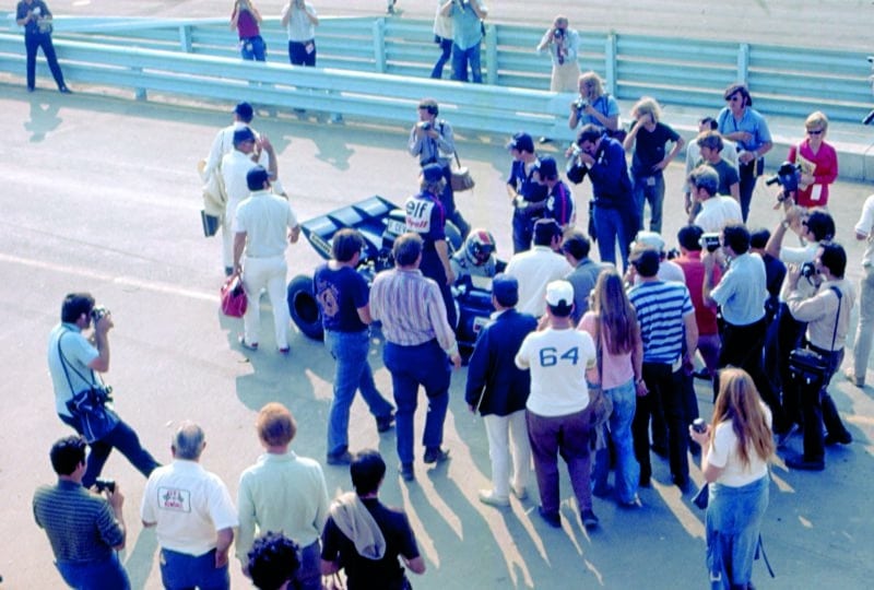 A crowd gathers around the Tyrrell of Francois Cevert after he won the 1971 US Grand Prix