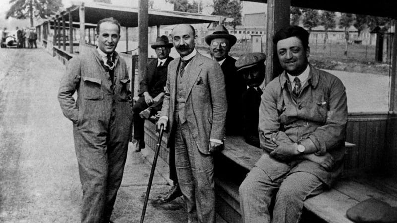 A young Enzo Ferrari (right) in the pits at Monza alongside Italian engineer and entrepreneur Nicola Romeo (middle) and engineer Giuseppe Morosi (left) in 1923
