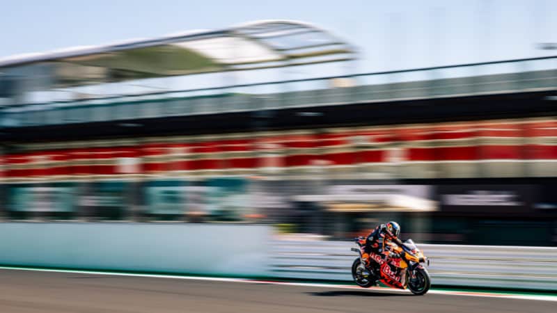 Rear wheel of KTM MotoGP bike lifts into the air as Brad Binder brakes for Turn 1 at 2022 MotoGP Misano round