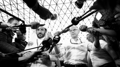 Mohammed Ben Sulayem and Stefano Domenicali speak in front of a line of microphones