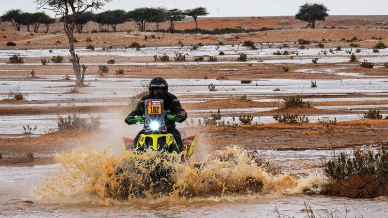 Quad splashing in desert puddles