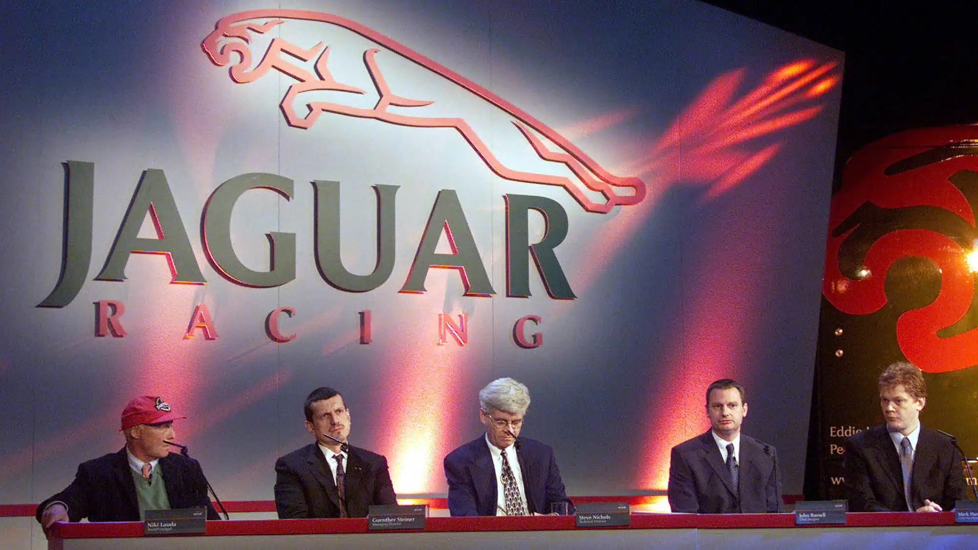 Niki Lauda Guenther Steiner and Steve Nichols sit at table during 2002 Jaguar F1 car launch