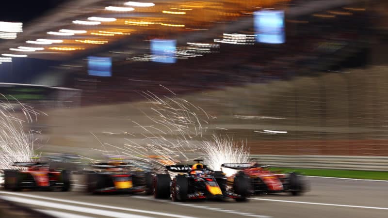 Sparks fly as F1 cars race off the start line in a blur at the 2023 Bahrain GP