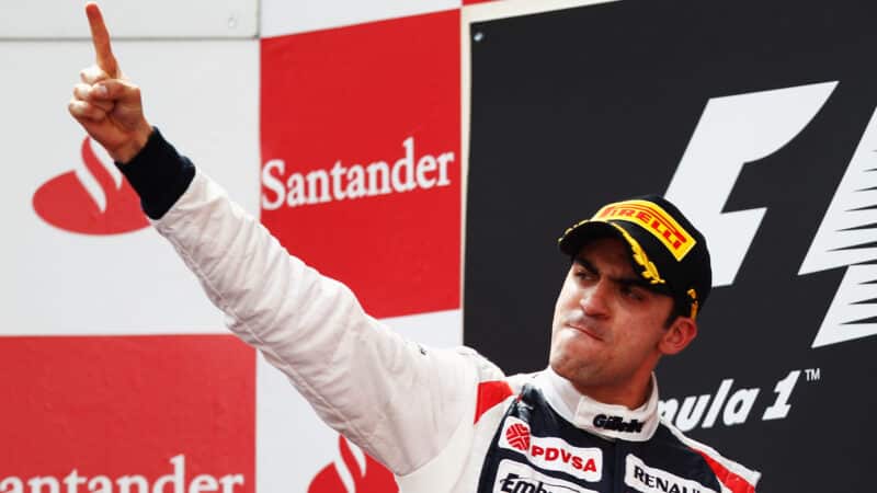 Pastor Maldonado points his finger on the podium after winning 2012 Spanish Grand Prix