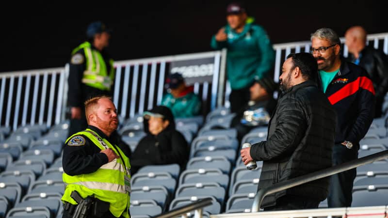 Police officer speaks to fans in the grandstands at 2023 Las Vegas Grand Prix