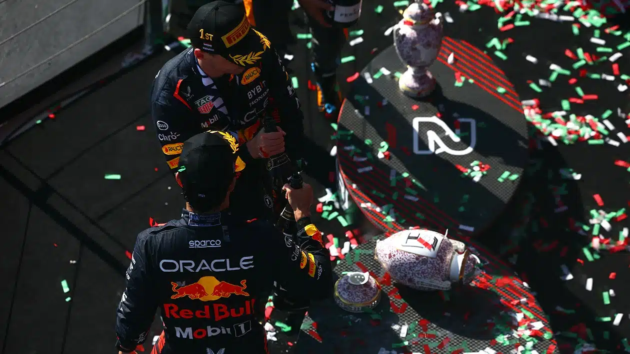 Max Verstappen and Sergio Perez look at broken trophy on the podium after 2023 F1 Hungarian Grand Prix