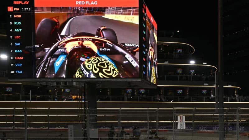 Spectators watch on a giant screen as Lando Norris crashes during the qualifying round for the 2025 Saudi Arabian GP