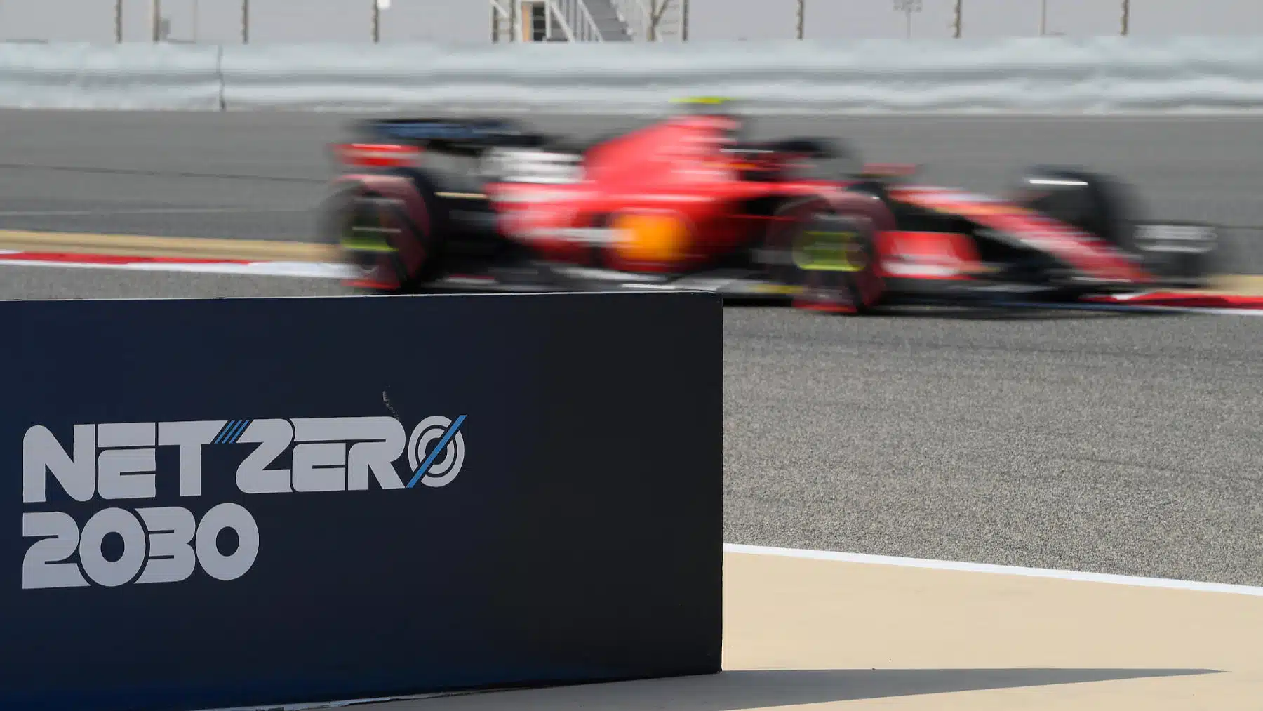 Net Zero 2030 sign for zero carbon footprint and Ferrari during practice for the 2023 Bahrain Grand Prix