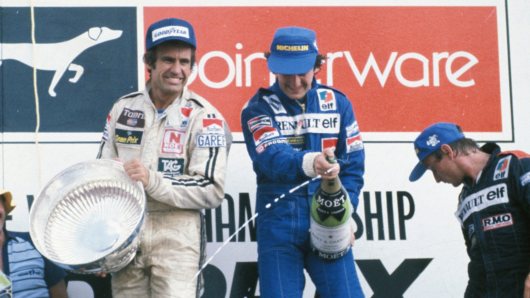 Alain Prost, Rene Arnoux (both Renault) and Carlos Reutemann (Williams-Ford) on the podium after the 1982 South African Grand Prix
