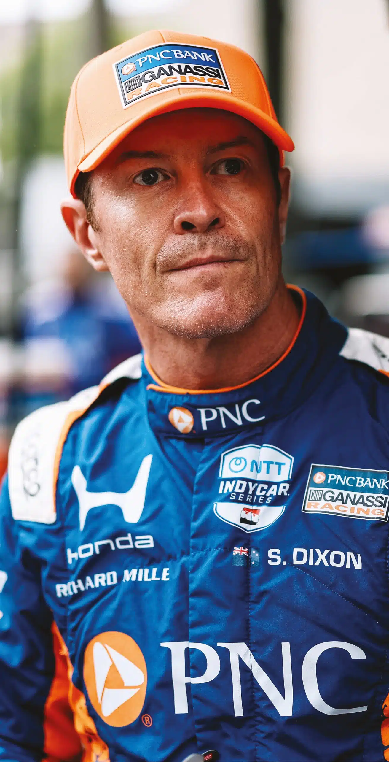 Scott Dixon in blue PNC Bank Chip Ganassi Racing Honda suit with orange cap during IndyCar team portrait